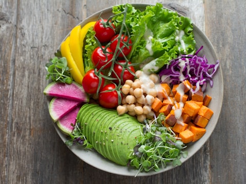 Fresh keto salad bowl with avocado and greens
